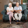 older people sat on a sofa talking